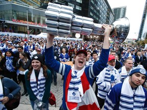 Toronto Maple Leaf fans get ready for the drop of the puck at the Leaf home opener against the Montreal Canadians outside the ACC in Maple Leaf Square in Toronto on Wednesday October 8, 2014. (Craig Robertson/Toronto Sun)
