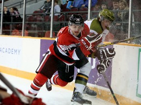 Ottawa's Trent Mallette battles North Bay's Kyle Wood in the corner during Tuesday night's game between the 67's and the Battalion at TD Place. (Chris Hofley/Ottawa Sun)