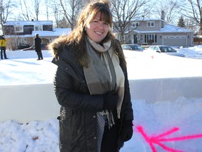 Laura Vincent points out the marks made in the snow by city workers who came to her house on Monaco Crescent early Monday morning. The city said it has started preparations to remove the boards from the east and north sides of the rink.
LOIS ANN BAKER/CORNWALL STANDARD-FREEHOLDER/QMI AGENCY