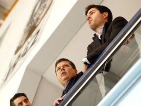 Maple Leafs GM Dave Nonis (centre) is flanked by assistant to the GM Brandon Pridham (left) and assistant GM Kyle Dubas at practice after the firing of Randy Carlyle yesterday. The trio has its work cut out for it trying to get its team into the playoffs. (Michael Peake/Toronto Sun)