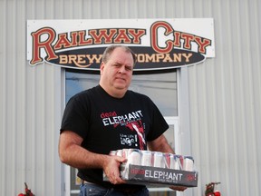 Railway City Brewing co-founder and vice president of sales and marketing Paul Corriveau holds a case of Dead Elephant Ale outside the brewery on Edward St. in St. Thomas. Railway City has been a major success story since the recession, expanding its production dramatically and tapping into demand for craft beer. (Ben Forrest/Times-Journal)