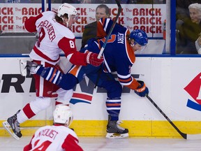 Jeff Petry battles Red Wings forward Justin Abdelkader for the puck during first-period action Tuesday at Rexall place. (David Bloom, Edmonton Sun)