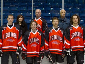 The Sarnia Legionnaires will auction off special warmup jerseys this month, with all proceeds going to St. Joseph's Hospice. Shown here are, back row from left: Maria Muscedere, fund development manager for the hospice, Paul Dusten, chairperson of the organization and Larry Lafranier, the executive director. Front row, same order, are Legionnaires players Tyler Prong, Jay Clarke, Nathan Mater and Kyler Keating. (Submitted photo by Anne Tigwell)