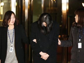 Cho Hyun-ah, centre, also known as Heather Cho, daughter of chairman of Korean Air Lines, Cho Yang-ho, leaves for a detention facility after a Korean court ordered her to be detained, at the Seoul Western District Prosecutor's office December 30, 2014. (REUTERS/Kim Hong-Ji)