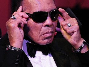 In this March 24, 2012 file photo, boxing legend Muhammad Ali adjusts his glasses on stage at Muhammad Ali's Celebrity Fight Night XVIII in Phoenix, Arizona.  (AFP PHOTO / ROBYN BECK / FILES)