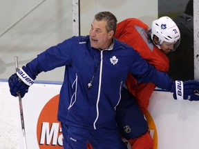 Leafs' Peter Horachek presses David Clarkson into the boards at the Mastercard Centre in Toronto on Tuesday January 6, 2015. (Craig Robertson/Toronto Sun)