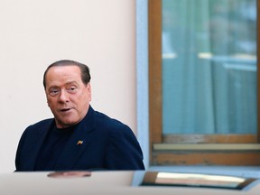 Former Italian prime minister Silvio Berlusconi looks on as he arrives at the Sacred Family Foundation in Cesano Boscone, a small town on the outskirts of Milan, in this May 9, 2014 file photo. REUTERS/Stefano Rellandini/Files