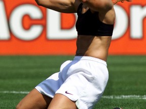 United States midfielder Brandi Chastain, with her jersey off, celebrates her  winning penalty kick against Chinese goalie Gao Hong at the Women's World Cup Final, in 1999, between the United States and China July 10 at the Rose Bowl. The United States won the final 5-4 on penalty kicks.(REUTERS FILE PHOTO)