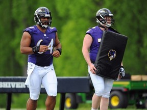 Ravens lineman John Urschel (left) looks up to veteran teammate Marshal Yanda. (Larry French/Getty Images/AFP/Files)