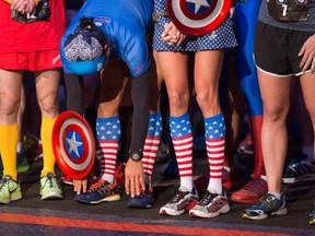 Runners in super hero outfits prepare at the start of the Avengers Super Heroes Half Marathon in and around the Disney Parks in Anaheim, California, in this file photo from November 16, 2014. Reuters/Eugene Garcia