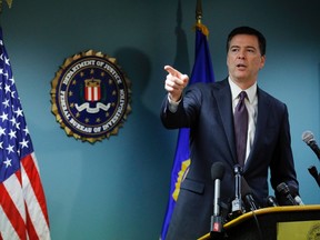 FBI Director James Comey takes a question from reporter during a news conference at the FBI office in Boston, Mass., Nov. 18, 2014.  REUTERS FILE/Brian Snyder