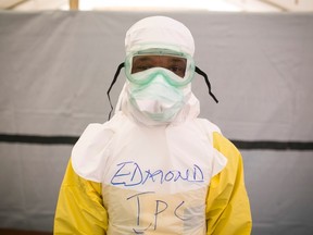 A health worker puts on protective gear before entering a quarantine zone at a Red Cross facility in the town of Koidu, Kono district in Eastern Sierra Leone in this December 19, 2014 file photo. REUTERS/Baz Ratner/Files