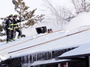 SEAN CHASE/DAILY OBSERVER
Renfrew firefighters search for hotspots on the roof of a county social housing complex on 41 Vimy Boulevard Jan. 7, 2015. All 45 residents were evacuated. Tenants were notified some will be allowed back home within two to three weeks, while those who lived in the more damaged wing could be waiting up to eight months before their apartments are restored.