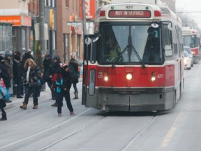 Passengers are unloaded from a streetcar as the extreme cold knocked old TTC streetcars out of service on Queen St. E. Wednesday, January 7, 2015. (Stan Behal/Toronto Sun)