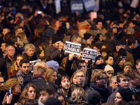 People hold placards reading in French "I am Charlie" during a gathering at the Place de la Republique (Republic square) in Paris. (AFP PHOTO)