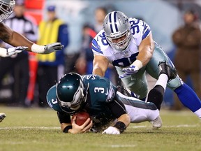 Mark Sanchez of the Philadelphia Eagles is sacked by Tyrone Crawford of the Dallas Cowboys at Lincoln Financial Field on December 14, 2014 in Philadelphia. (Mitchell Leff/Getty Images/AFP)