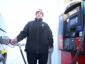 Gino Donato/The Sudbury Star
Michael Creasey gases up his van in Sudbury in this file photo. Gas prices in most of the province are significantly lower than Sudbury's.