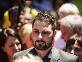Carl Pistorius, the brother of paraolympian star Oscar Pistorius, leaves the High Court following his brother's sentencing in Pretoria, on October 21, 2014. (AFP PHOTO/GIANLUIGI GUERCIA)