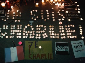 A makeshift memorial is seen outside the Consulate General of France during a vigil for the victims of an attack on satirical magazine Charlie Hebdo in Paris, in San Francisco, California January 7, 2015. The youngest of three French nationals being sought by police for a suspected Islamist militant attack that killed 12 people at a satirical magazine on Wednesday turned himself in to the police, an official at the Paris prosecutor's office said. The hooded attackers stormed the Paris offices of Charlie Hebdo, a weekly known for lampooning Islam and other religions, in the most deadly militant attack on French soil in decades. REUTERS/Stephen Lam (UNITED STATES - Tags: CRIME LAW POLITICS CIVIL UNREST)