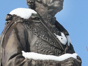 The statue of Sir John A. Macdonald in City Park in Kingston, Ont., wears a mantle of white following a snowfall in this Jan. 4, 2010 file photo. (MICHAEL LEA/QMI Agency)
