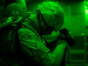 A Canadian Armed Forces member rests onboard a CC-177 Globemaster III aircraft containing military equipment destined for Iraq, during Operation IMPACT on August 28, 2014. Photo: MCpl Patrick Blanchard, Canadian Forces Combat Camera