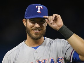 J.P. Arencibia #7 of the Texas Rangers salutes a fan who taunts him after hitting a three-run home run in the seventh inning during MLB game action against the Toronto Blue Jays on July 18, 2014 at Rogers Centre in Toronto, Ontario, Canada. (Tom Szczerbowski/Getty Images/AFP)