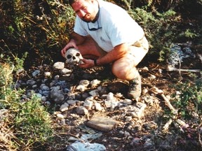 Chris Malette handles a skull in ‘the boneyard’ just off the coastal highway between Gonaives and St. Marc, Haiti during a trip there in 1995. - SUBMITTED PHOTO