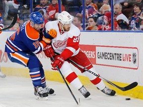 Detroit Red Wings forward Johan Franzen (93) and Edmonton Oilers forward Teddy Purcell (16) battle behind the Red Wings net during the second period at Rexall Place. (Perry Nelson-USA TODAY Sports)