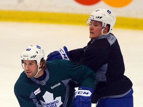 Troy Bodie battles for position with Jake Gardiner during Maple Leafs practice at the MasterCard Centre in Toronto on Thursday January 8, 2015. (Dave Abel/Toronto Sun)