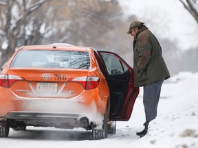 A man gets into a taxi near 93 Street and 63 Avenue in Edmonton, Alta., on Monday, Dec. 29, 2014. Taxis, Uber, and public transit are alternatives for Edmontonians traveling home on New Year's Eve. Ian Kucerak/Edmonton Sun