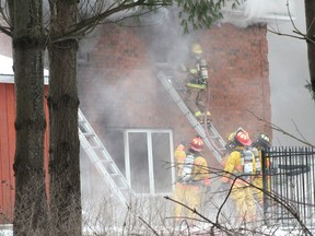 Firefighters responded to a stubborn house fire near Reece’s Corners on Thursday. Volunteers from the Wyoming Fire Department were assisted by their Petrolia and North Enniskillen colleagues in an effort to end the blaze. (BRENT BOLES, QMI Agency)