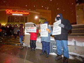 People protest Bill Cosby's appearance at Budweiser Gardens in London, Ontario on Thursday, January 8, 2015. (DEREK RUTTAN, The London Free Press)