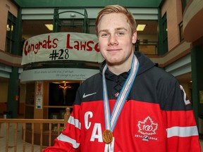 Team Canada member Lawson Crouse wears his gold medal, won at the 2015 World Junior Hockey Championship, to show classmates and teachers at Holy Cross Catholic Secondary School on Thursday. (Julia McKay/The Whig-Standard)