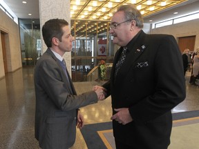 Mayor Brian Bowman (left)  shakes hands with Bruno Brunichon, the Honorary Consul for France in Winnipeg, before an event at City Hall to remember those killed by terrorists in France during the attack on a magazine office in Paris.
