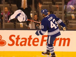 Toronto centre Nazem Kadri lifts a tossed jersey off the ice after Wednesday’s loss. (JACK BOLAND/Toronto Sun)