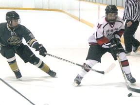 Max Steeves of the Northern Vikings protects the puck from St. Patrick's Fighting Irish player Ryan Greenaway during the teams' Lambton Kent high school boys hockey game Wednesday at Clearwater Arena. The clubs skated to a 3-3 draw. (TERRY BRIDGE/THE OBSERVER)