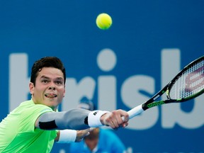 Milos Raonic reaches to return the ball to Sam Groth during their singles quarterfinal at the Brisbane International tennis tournament on Friday, Jan. 9, 2015. (Jason Reed/Reuters)