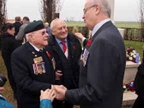 Minister Julian Fantino speaks with Veteran Sheridan Atkinson and local resident Oviglio Monti following a commemorative ceremony at the Villanova Canadian War Cemetery. Mr. Monti was assisted by the Royal Canadian Regiment after being orphaned during the war. Friday November 28, 2014. Veteran Affairs Supplied Photos
