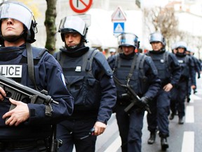 French intervention police take up position near the scene of a hostage taking at a kosher supermarket in Paris, Jan. 9, 2015. (YOUSSEF BOUDLAL/Reuters)