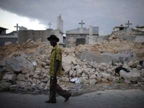 A man walks in front of a destroyed cemetery after an earthquake in Port-au-Prince January 14, 2010.   REUTERS/Jorge Silva