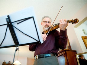 Orchestra London?s former concertmaster Joe Lanza, shown here in his London home, says musicians want to rebuild the orchestra ?from the bottom up.? (CRAIG GLOVER, The London Free Press)