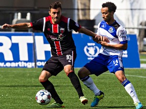 Edmonton's Cristian Raudales challenges Ottawa's Sinisa Ubiparipovic during FC Edmonton's NASL soccer match against Ottawa Fury FC at Commonwealth Stadium in Edmonton, Alta., on Sunday, July 13, 2014. The match ended in a 0-0 draw. Codie McLachlan/Edmonton Sun/QMI Agency