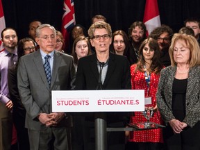 Premier Kathleen Wynne, surrounded by her Ottawa caucus and post-secondary students, addresses the media in Ottawa on her cross-province tour of Colleges and Universities. Ontario January 9, 2015. Errol McGihon/Ottawa Sun/QMI Agency