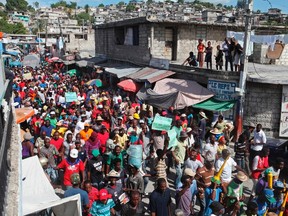 Demonstrators march through the streets during an anti-government protest in Port-au-Prince, Haiti, Dec. 5, 2014. (MARIE ARAGO/Reuters)