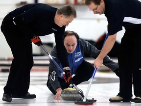 Skip Wade White (centre) makes a shot during a Senior Men's Curling Zones game against Rick Kravontka at the Ottewell Curling Club, 4205 - 102 Ave., in Edmonton Alta., on Friday Jan. 9, 2015. David Bloom/Edmonton Sun/QMI Agency