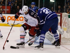 Blue Jackets’ Fedor Tyutin (left) and Maple Leafs’ James Van Riemsdyk fight for control of the puck last night at the Air Canada Centre. (JACK BOLAND/TORONTO SUN)