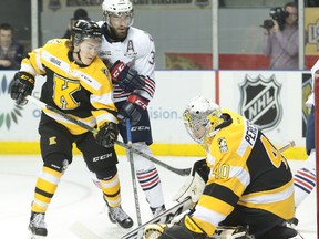 Kingston Frontenacs goaltender Lucas Peressini covers up a shot as Oshawa Generals forward Hunter Smith tries to push his way past defenceman Chad Duchesne during the first period of an OHL game at the Rogers K-Rock Centre on Friday night. Kingston won 3-2 in a shootout. (Elliot Ferguson/The Whig-Standard)