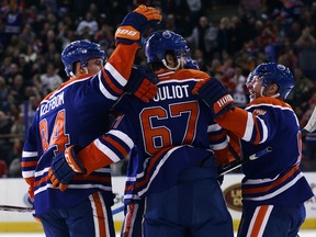Derek Roy, right, celebrates the Oilers first goal against the Blackhawks with teammates Benoit Pouliot, who scored, and Oscar Klefbom Friday at Rexall Place. (David Bloom, Edmonton Sun)