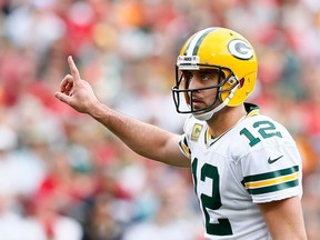 Aaron Rodgers #12 of the Green Bay Packers signals to his offense during the game against the Tampa Bay Buccaneers at Raymond James Stadium on December 21, 2014 in Tampa, Florida. 
(Kevin C. Cox/Getty Images/AFP)