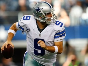 Tony Romo #9 of the Dallas Cowboys rolls out against the Detroit Lions during the first half of their NFC Wild Card Playoff game at AT&T Stadium on January 4, 2015 in Arlington, Texas. (Tom Pennington/Getty Images/AFP)